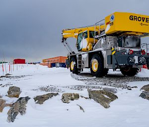 A crane parked in the snow.