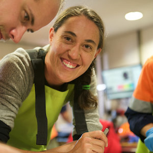 Sophie Bestley sorting specimens aboard the Aurora Australis during Kerguelen Axis voyage. (Photo: Nick Roden) Expeditioner smiling at camera.