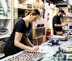 Chef concentrating on her work in the kitchen
