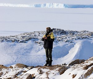 Expeditioner with expansive ice sheet in background.