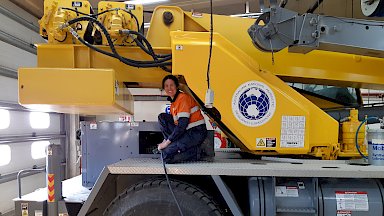 Mechanic on heavy machinery performing checks