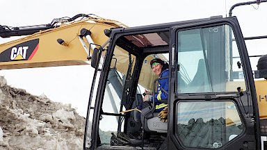 Operator in cabin of excavator