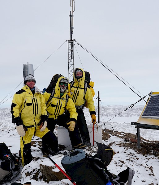 Group of expeditioners standing near VHF repeater