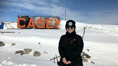 An expeditioner stands in front of the Casey station fuel storage