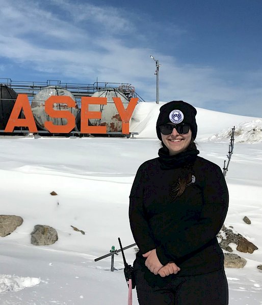 An expeditioner stands in front of the Casey station fuel storage