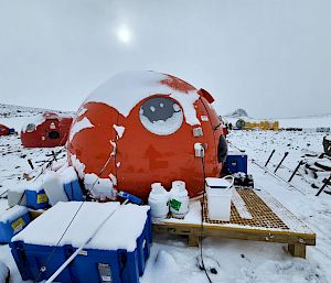 Close up of a snow-covered tent and a wide shot of EDBC.