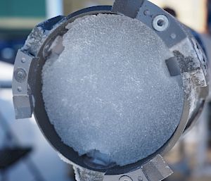 A core of ice inside a metal drill.