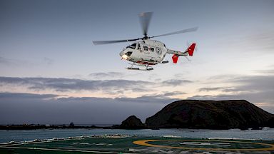 A helicopter hovering above the helipad of RSV Nuyina