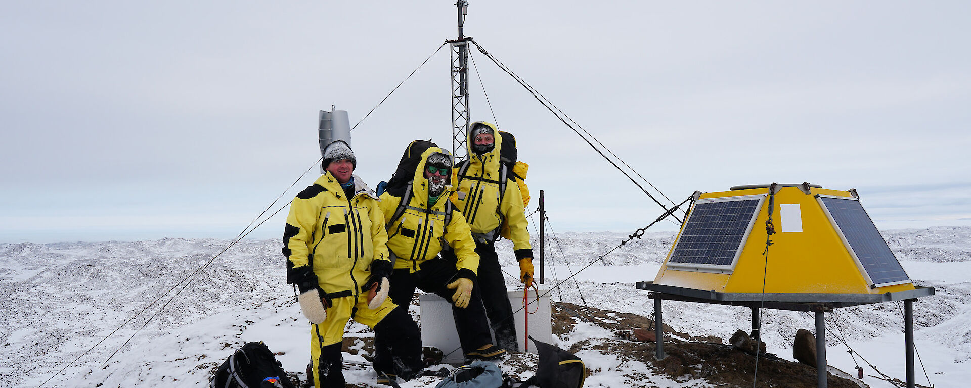 Group of expeditioners standing near VHF repeater