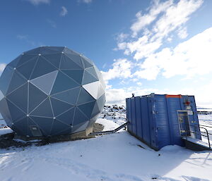 ANARESAT Radome satellite dish next to a supporting building